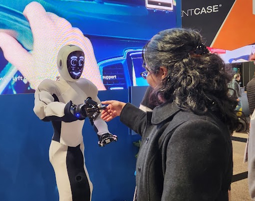Eve from Halodi Robotics shakes hands at CES 2023 with Karinne Ramirez-Amaro, associate professor at Chalmers University of Technology and head of IEEE Robotics and Automation Society’s Women in Engineering chapter. (Image source: Andra Keay)